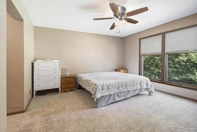 5293 Bartonville Rd, Belding, MI 48809 - bedroom featuring light colored carpet, ceiling fan, and a textured ceiling