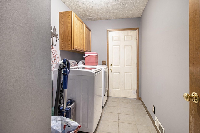 5293 Bartonville Rd, Belding, MI 48809 - laundry room with cabinet space, washing machine and clothes dryer, light tile patterned floors, and a textured ceiling