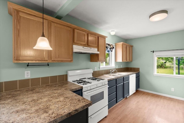 524 Kiddville St, Belding, MI 48809 - kitchen with white appliances, under cabinet range hood, light wood-style floors, pendant lighting, and brown cabinets