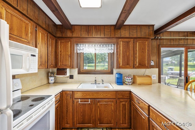 4410 Delaware Rd, Fremont, MI 49412 - kitchen featuring white appliances, beamed ceiling, light countertops, plenty of natural light, and wood walls