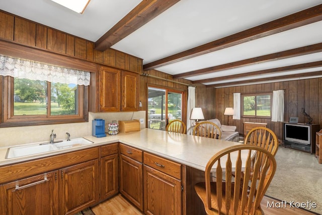 4410 Delaware Rd, Fremont, MI 49412 - kitchen with open floor plan, light countertops, a peninsula, wood walls, and brown cabinets