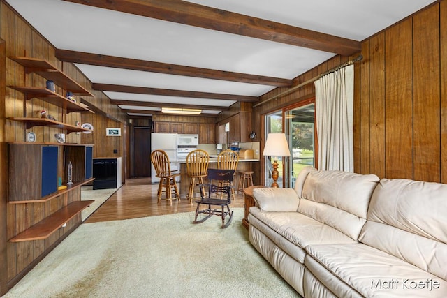 4410 Delaware Rd, Fremont, MI 49412 - living area with wood walls, beamed ceiling, light wood-style flooring, and light colored carpet