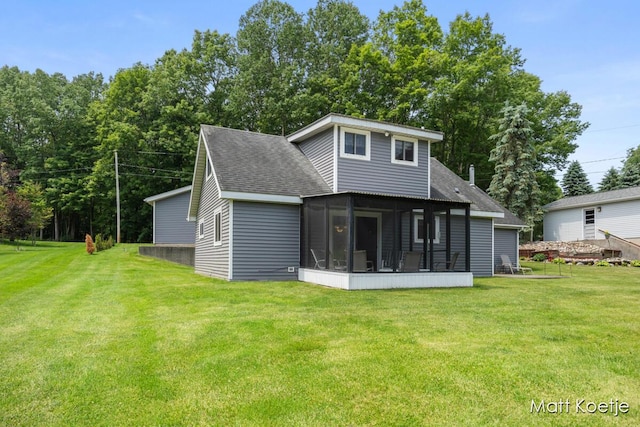 4410 Delaware Rd, Fremont, MI 49412 - back of property featuring a sunroom, roof with shingles, and a lawn