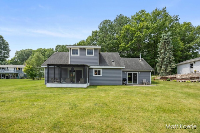 4410 Delaware Rd, Fremont, MI 49412 - rear view of property with a sunroom, a lawn, and a shingled roof