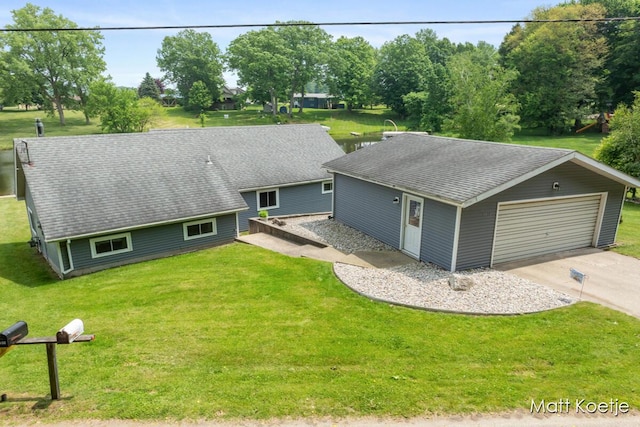 4410 Delaware Rd, Fremont, MI 49412 - ranch-style home with a detached garage, a front yard, and roof with shingles