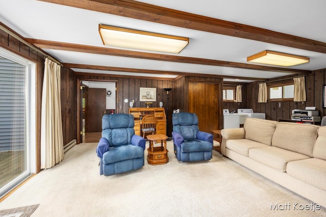 4410 Delaware Rd, Fremont, MI 49412 - living area with light carpet, beam ceiling, wood walls, and washing machine and dryer