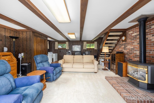 4410 Delaware Rd, Fremont, MI 49412 - living room with a wood stove, carpet floors, wood walls, beamed ceiling, and stairs