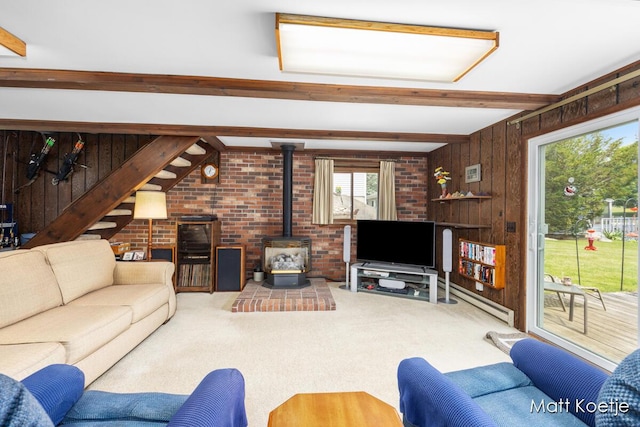 4410 Delaware Rd, Fremont, MI 49412 - carpeted living area with a wood stove, baseboard heating, wood walls, and beam ceiling