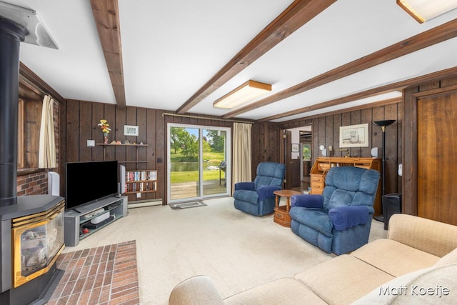 4410 Delaware Rd, Fremont, MI 49412 - carpeted living area featuring a wood stove, beamed ceiling, and wood walls
