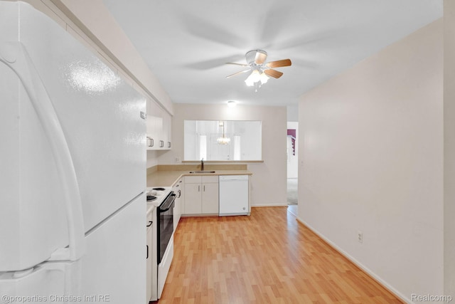 3 Cornell Ct Unit 27, Dearborn, MI 48124 - kitchen featuring white appliances, light countertops, ceiling fan, white cabinetry, and light wood-type flooring