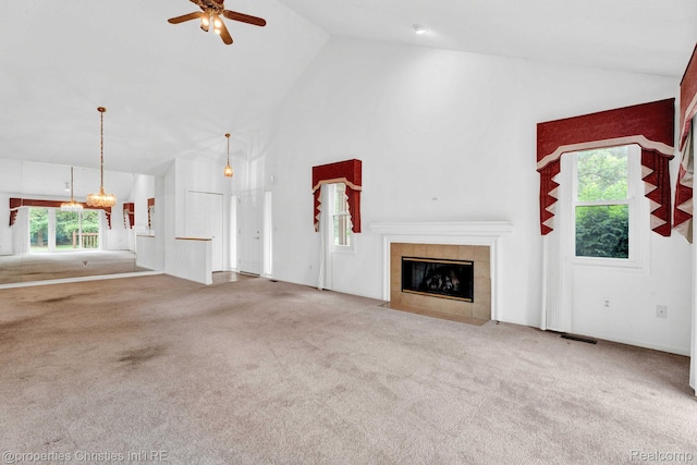 3 Cornell Ct Unit 27, Dearborn, MI 48124 - unfurnished living room with high vaulted ceiling, a tile fireplace, a ceiling fan, carpet floors, and a chandelier