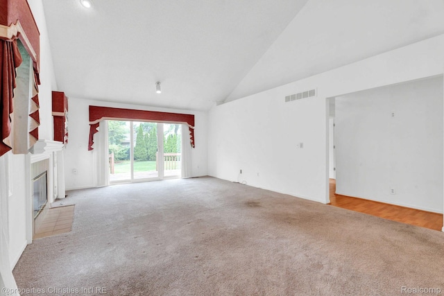 3 Cornell Ct Unit 27, Dearborn, MI 48124 - unfurnished living room featuring carpet flooring, a fireplace, and high vaulted ceiling