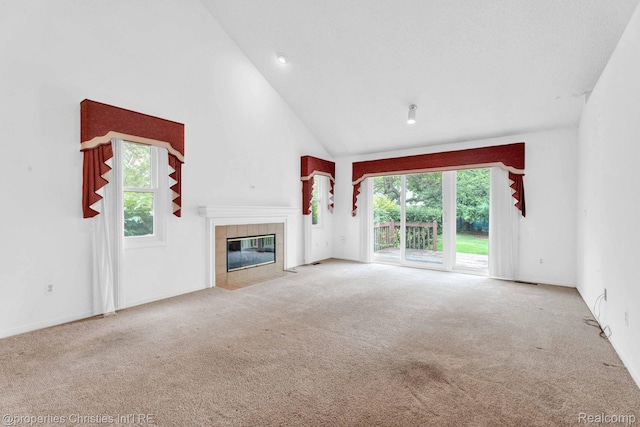 3 Cornell Ct Unit 27, Dearborn, MI 48124 - unfurnished living room featuring carpet floors, healthy amount of natural light, a tile fireplace, and high vaulted ceiling