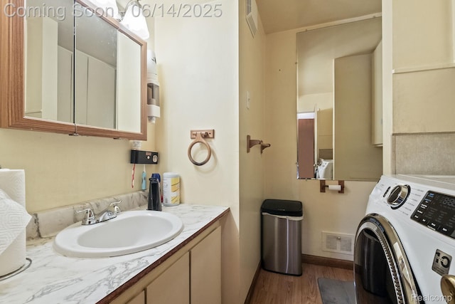 37649 Castle Dr, Romulus, MI 48174 - bathroom featuring washer / dryer, wood finished floors, and vanity