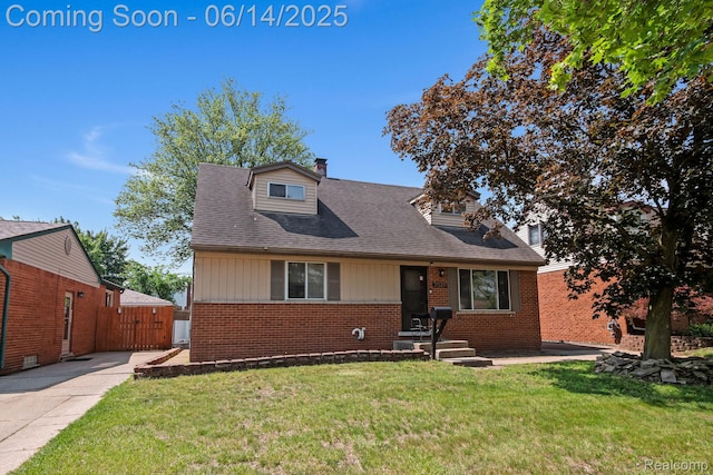 37649 Castle Dr, Romulus, MI 48174 - view of front facade featuring brick siding, a chimney, a front yard, a gate, and concrete driveway