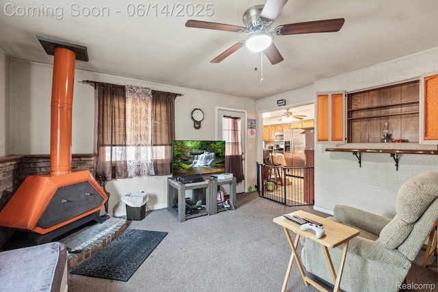 37649 Castle Dr, Romulus, MI 48174 - carpeted living room with a wood stove, ceiling fan, and healthy amount of natural light