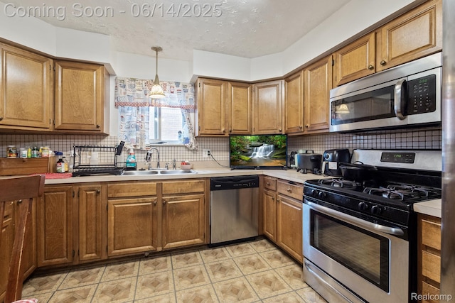 37649 Castle Dr, Romulus, MI 48174 - kitchen featuring appliances with stainless steel finishes, light countertops, decorative backsplash, brown cabinetry, and a textured ceiling