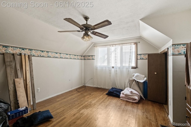37649 Castle Dr, Romulus, MI 48174 - additional living space featuring wood finished floors, lofted ceiling, a ceiling fan, and a textured ceiling