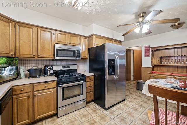 37649 Castle Dr, Romulus, MI 48174 - kitchen with stainless steel appliances, light countertops, ceiling fan, and decorative backsplash