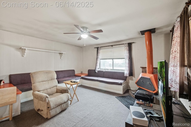37649 Castle Dr, Romulus, MI 48174 - carpeted living room with a ceiling fan and a wood stove