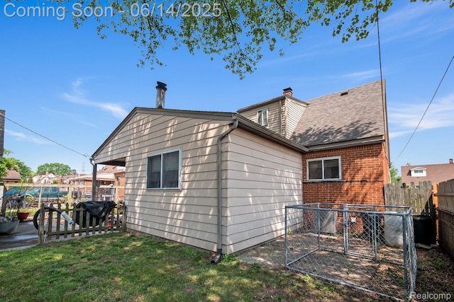 37649 Castle Dr, Romulus, MI 48174 - back of property with brick siding, a shingled roof, and a chimney