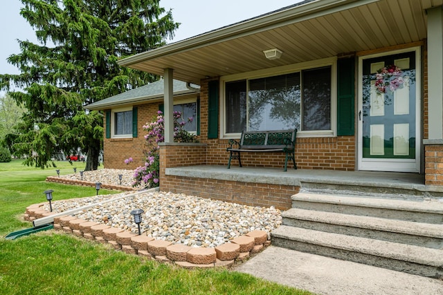 10001 Date Rd, Baroda, MI 49101 - entrance to property with covered porch, brick siding, and a lawn