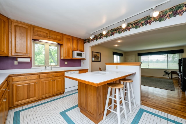 10001 Date Rd, Baroda, MI 49101 - kitchen featuring white appliances, light tile patterned flooring, light countertops, and track lighting