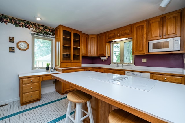 10001 Date Rd, Baroda, MI 49101 - kitchen with white appliances, brown cabinets, and light countertops
