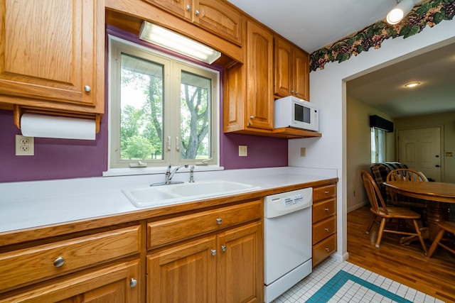 10001 Date Rd, Baroda, MI 49101 - kitchen with white appliances, light countertops, light tile patterned floors, and brown cabinets