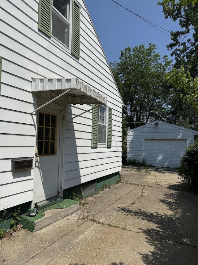 911 Napier Ave, Saint Joseph, MI 49085 - view of home's exterior featuring concrete driveway, a garage, and an outdoor structure