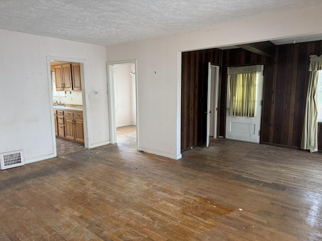 911 Napier Ave, Saint Joseph, MI 49085 - spare room featuring wood-type flooring and a textured ceiling