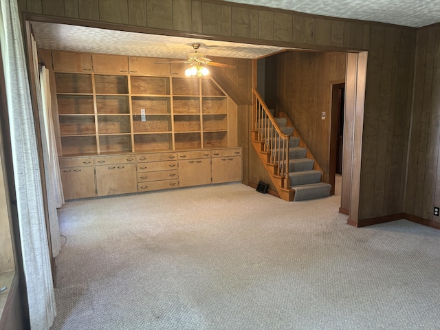 2523 E Wildcat, Saint Johns, MI 48879 - basement with wooden walls, ceiling fan, carpet floors, and stairs