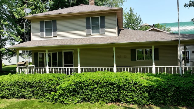2523 E Wildcat, Saint Johns, MI 48879 - view of front of property featuring a chimney, covered porch, and roof with shingles