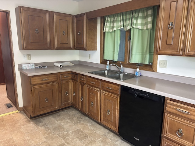 2523 E Wildcat, Saint Johns, MI 48879 - kitchen featuring black dishwasher, light countertops, and stone finish floors
