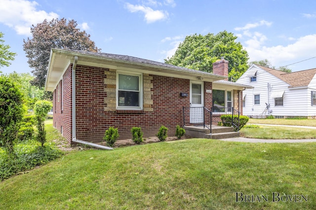 1665 7th St NW, Grand Rapids, MI 49504 - view of front of property featuring brick siding, a front lawn, and a chimney