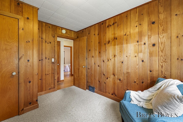 1665 7th St NW, Grand Rapids, MI 49504 - living area featuring wooden walls and carpet floors
