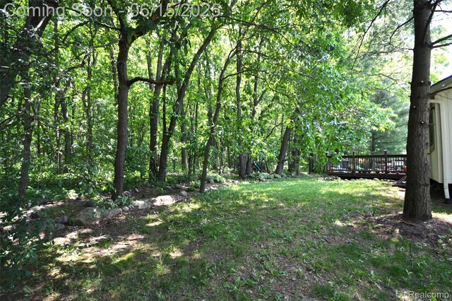10010 Orchard Ridge Ct, Holly, MI 48442 - view of yard featuring a wooden deck and a wooded view