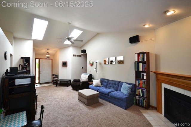 10010 Orchard Ridge Ct, Holly, MI 48442 - living area with a skylight, light colored carpet, a tiled fireplace, vaulted ceiling, and ceiling fan