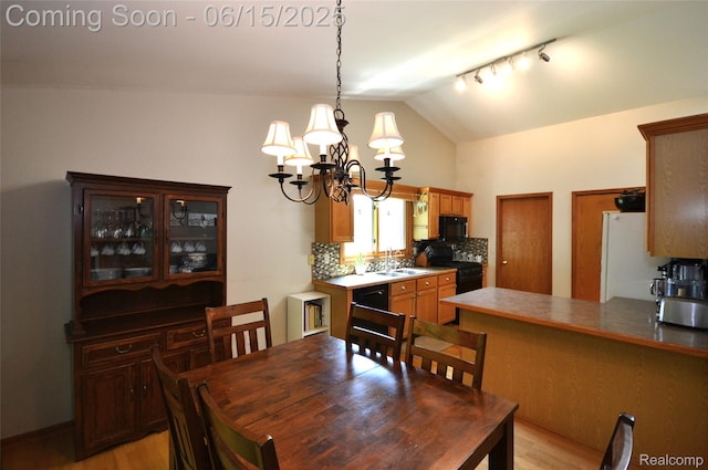 10010 Orchard Ridge Ct, Holly, MI 48442 - dining area featuring a chandelier, light wood finished floors, and lofted ceiling