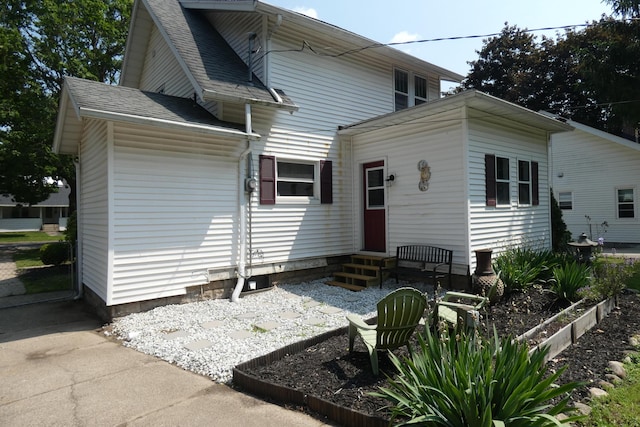 552 W Main St, Niles, MI 49120 - rear view of house featuring entry steps and roof with shingles