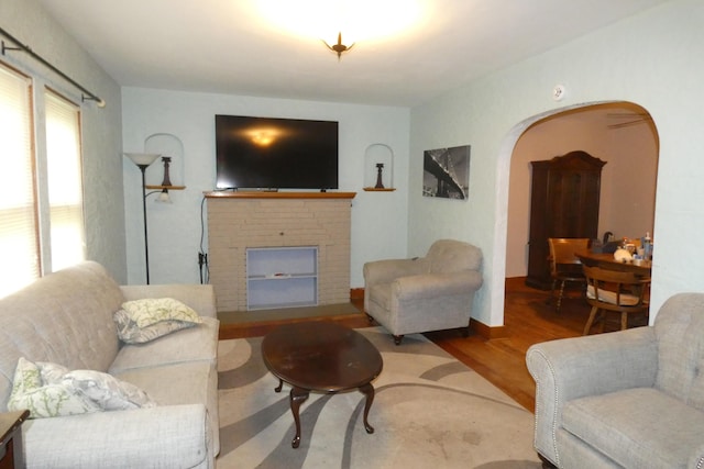 552 W Main St, Niles, MI 49120 - living area featuring wood finished floors, arched walkways, and a fireplace