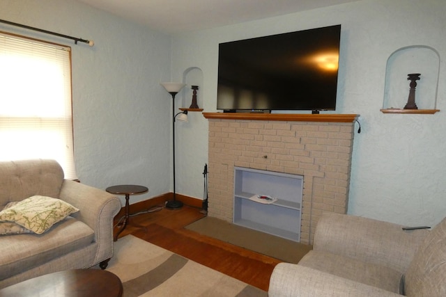 552 W Main St, Niles, MI 49120 - living room featuring wood finished floors and a fireplace