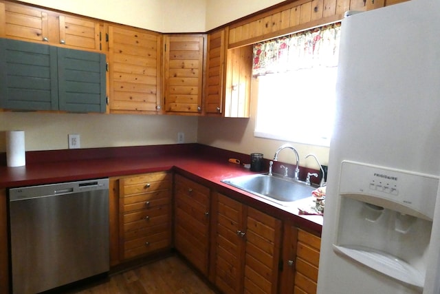 552 W Main St, Niles, MI 49120 - kitchen with white refrigerator with ice dispenser, stainless steel dishwasher, dark countertops, brown cabinetry, and dark wood finished floors