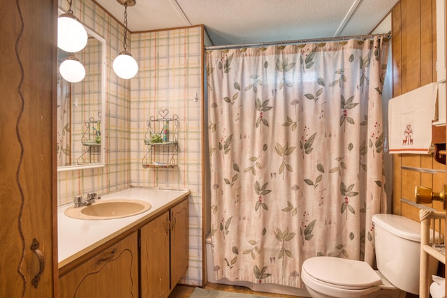 8182 Hardy Dr, Newaygo, MI 49337 - bathroom with vanity, a shower with shower curtain, wallpapered walls, and a textured ceiling