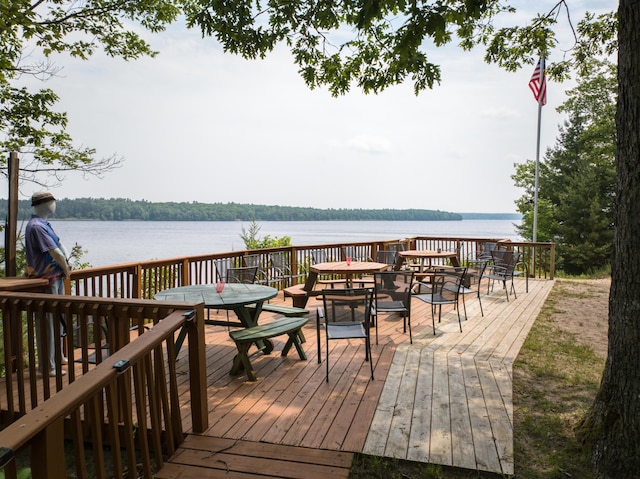8182 Hardy Dr, Newaygo, MI 49337 - wooden deck with outdoor dining space and a water view