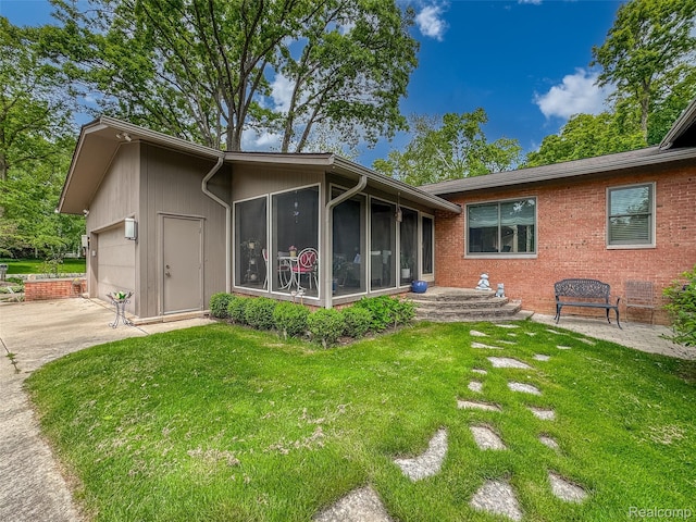 5259 Echo Rd, Bloomfield, MI 48302 - back of house with a sunroom, a yard, driveway, and a garage