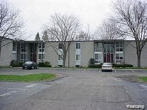 4030 W 13 Mile Rd Unit 3, Royal Oak, MI 48073 - view of property featuring uncovered parking
