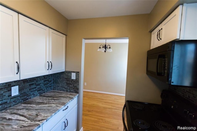 4030 W 13 Mile Rd Unit 3, Royal Oak, MI 48073 - kitchen with black appliances, a chandelier, white cabinets, and light stone countertops