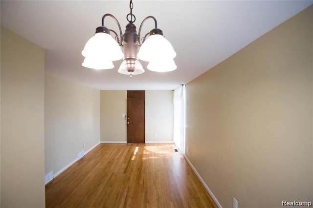 4030 W 13 Mile Rd Unit 3, Royal Oak, MI 48073 - unfurnished room with a chandelier and wood finished floors