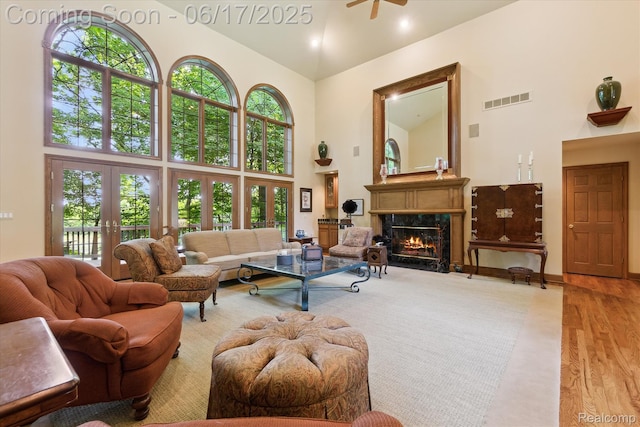 2020 Pine Hollow Trl, Brighton, MI 48114 - living room featuring high vaulted ceiling, plenty of natural light, a high end fireplace, wood finished floors, and a ceiling fan